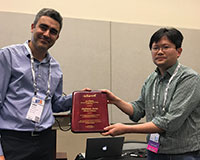 Omar Besbes (committee chair) congratulates Stefanus Jasin (l-r).
