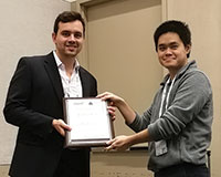 Florian Ederer (right) receives award on behalf of Tristan L. Botelho