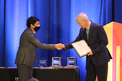 Somya Singhvi accepts award from Steve Graves