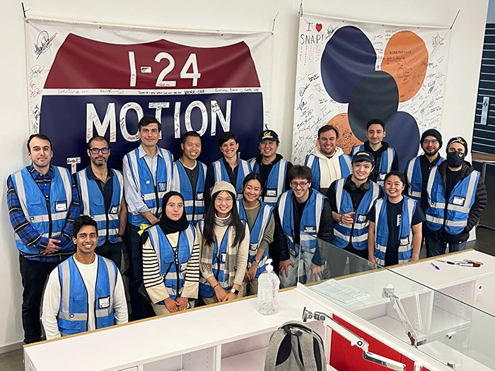 UC Berkeley-affiliated CIRCLES members pose in front of signed I-24 MOTION and CIRCLES banners 